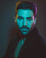 Young man in trendy clothes and neon lights