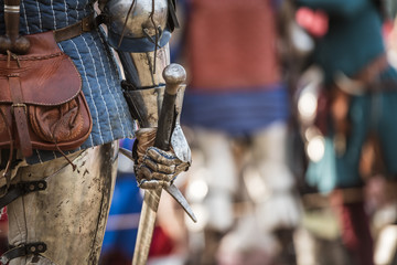 Knights tournament - detail of armed hand and sword.