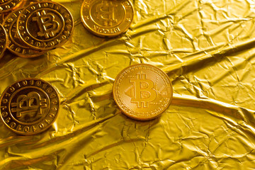 The Bitcoin cryptocurrency in gold texture  image background.