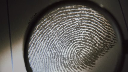 A police officer investigate fingerprints. Macro shot.