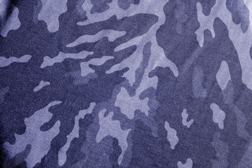 Old camouflage cloth with blur effect in blue tone. © pavelalexeev