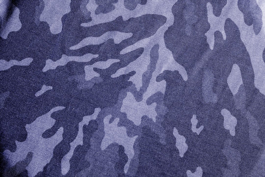 Old camouflage cloth with blur effect in blue tone.