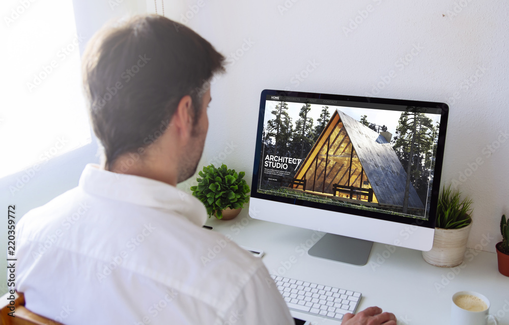 Poster man browsing architecture website on computer