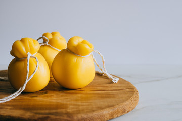 Scamorza cheese on a wooden board, marble background, copy space.