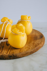 Scamorza cheese on a wooden board, marble background, copy space.