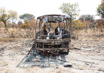 Burned bus at the side of the road