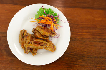 A plate of New Orleans Chicken with side dishes. Put on wooden table. Top View.