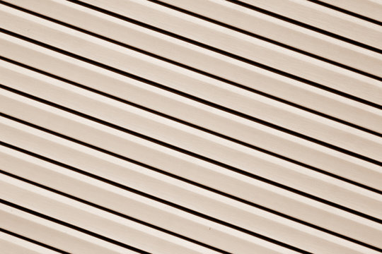 Plastic siding surface in brown color.