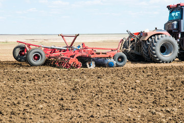 tractor on the field spring plowing of fields