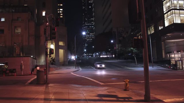 Timelapse of downtown los angeles 5th and Grand California America!  cars fly by streaks of headlights and people pass by at night