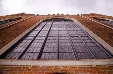 Gdansk Old City, Saint Mary Church wall with huge stained glass window. View from low point.