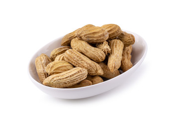 Dried peanuts in white ceramic bowl isolated on a white background