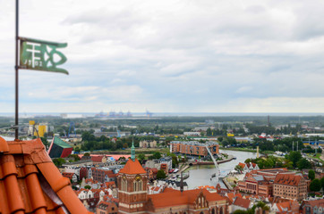 City of Gdansk in Poland, aerial view over the Old Town, view from Saint Mary's Church Tower. Cityscape of Gdansk with river Motlawa view at cloudy day. Miniature effect. Selective focus