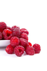 Harvested juicy ripe raspberries fruit on white background..