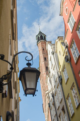 The historic streetlight against the background of blue sky and Old City street in Gdansk, Poland.