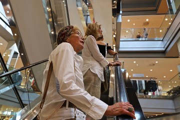 Adult daughter with her mother during shopping at Kurfürstendamm and Tauentzienstraße in Berlin-City, Germany.