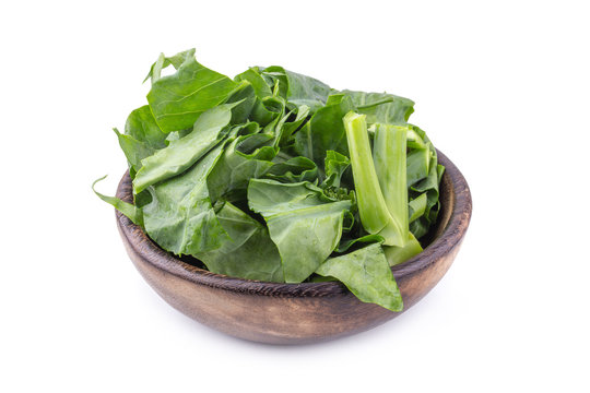 Chinese kale vegetable Cut into pieces in a wooden bowl isolated on white background
