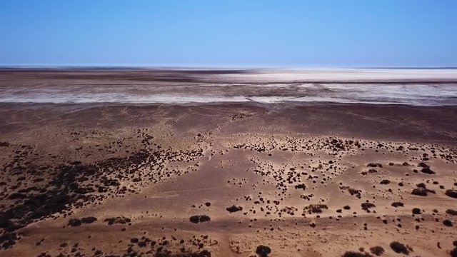 Aerial tracking shot over Lake Eyre salt lake in outback South Australia. Very remote area and the lowest natural point in Australia. Near Marree on the Oodnadatta track.