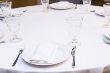 Enjoy a round dining table with white tablecloth in the restaurant