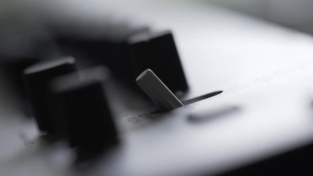 Music producer switching settings on electronic music sampler