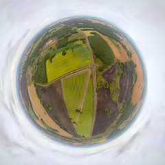Helicopter drone shot. Aerial photography of a green field, roan and forest. Panoramic city 360 ...