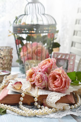 vintage style still life with roses and old book