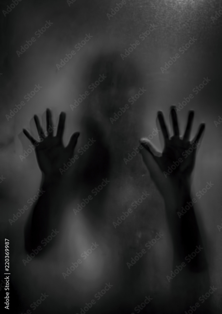 Wall mural horror ghost girl behind the matte glass in black and white. halloween festival concept.