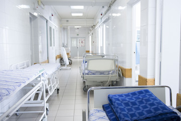 hospital bed rolling into the hallway of the hospital