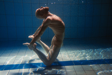 athletic sport man underwater in the swimming pool