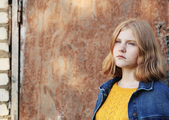 sad teenager girl on background brown wall