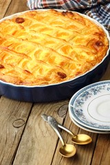 Cheese cake with tangerine.With plate and spoons.In blue baking tray. Cheese pie.Desert .Homemade.Rustic background