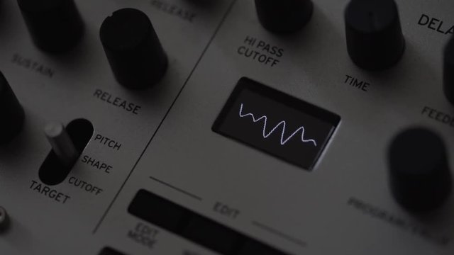 Music composer creating waveform on synthesiser analog sampler
