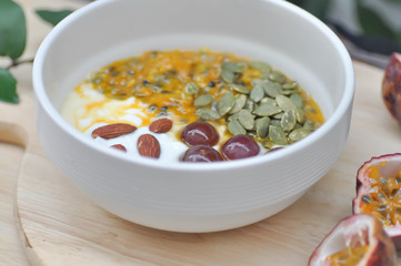 yogurt with passion fruit, almond ,sunflower seed and grape