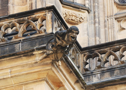 A very old statue on part of prague castle in czech republic in europe. Decoration on balcon.