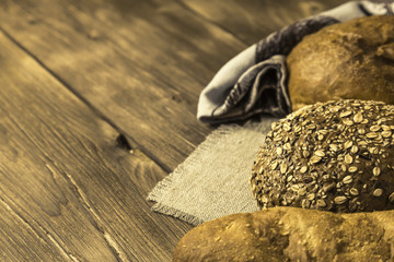 Rustic still life. Food. Assortment of fresh baked bread in the bakery on the background of a wooden table