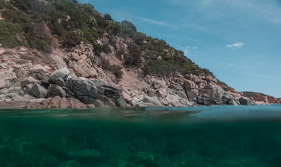 Fototapeta na wymiar Half underwater view of beautiful sea in Sardinia (Cala Regina) italy