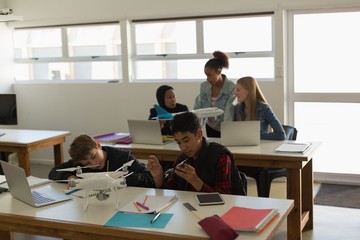 Students discussing over model aeroplane in training institute
