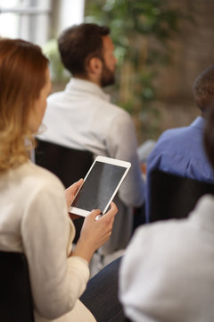 Back View Of Woman With Cell Phone At Business Meeting