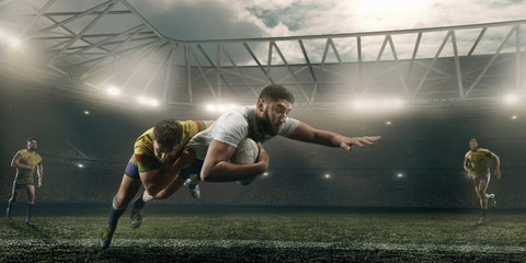 Rugby players fight for the ball on professional rugby stadium - obrazy, fototapety, plakaty
