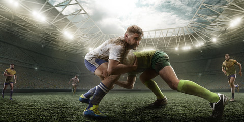 Rugby players fight for the ball on professional rugby stadium