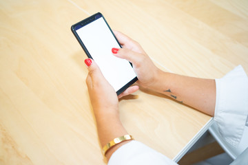 Young entrepreneur girl with the phone in her hand, showing her new app. The device screen is blank for your photomontage