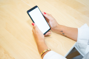 Young entrepreneur girl with the phone in her hand, showing her new app. The device screen is blank for your photomontage