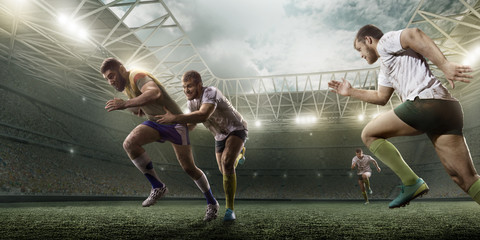 Rugby players fight for the ball on professional rugby stadium