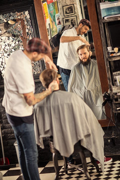 man hairdresser is cutting hair.