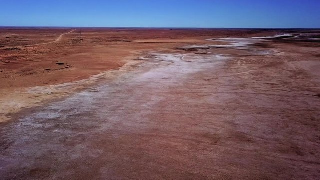 Aerial tracking shot over Lake Eyre salt lake in outback South Australia. Very remote area and the lowest natural point in Australia. Near Marree on the Oodnadatta track.