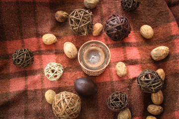 Autumn decor with candles on the background in a cage