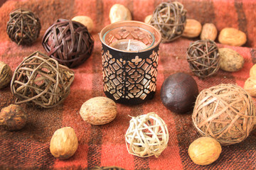 Autumn decor with candles on the background in a cage