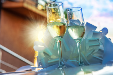Wedding concept with champagne glasses against sunset light