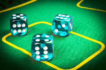 risk concept - playing dice on a green gaming table. Playing a game with dice. Blue casino dice rolls. Rolling the dice concept for business risk, chance, good luck or gambling