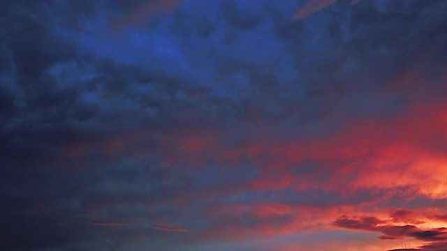 Aerial pan shot over clouds during beautiful sunset time-lapse